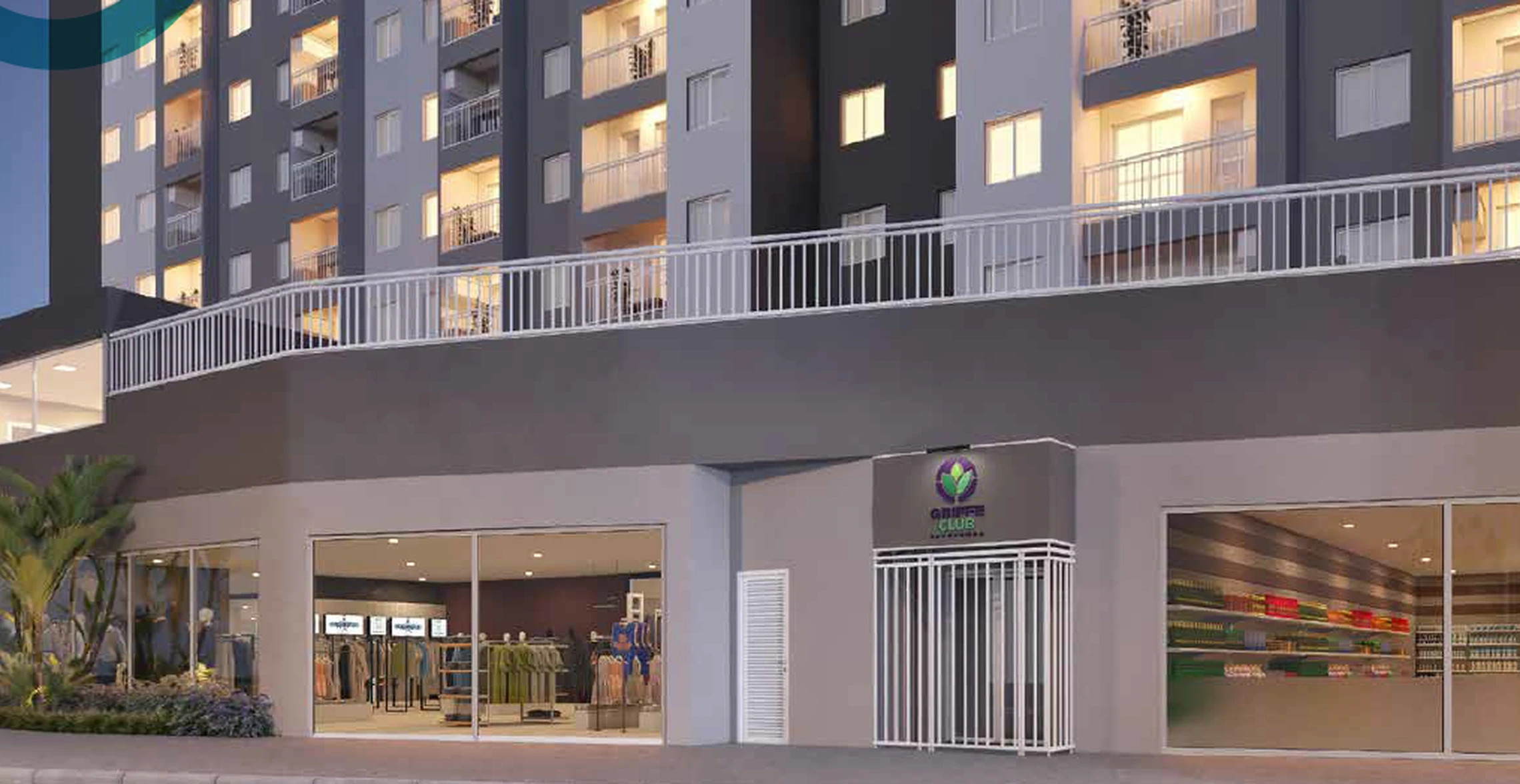 Portaria do Griffe Club Sapopemba ao entardecer, com a placa do empreendimento e lojas no térreo